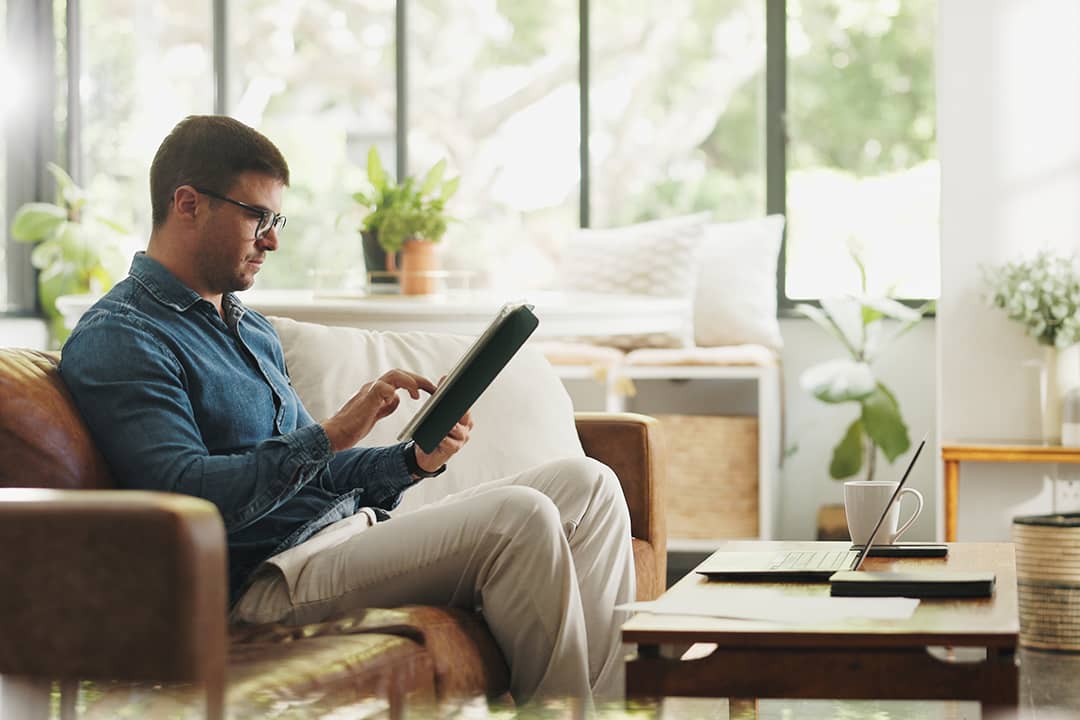 An account manager working on a client portfolio and research before an online meeting at home.